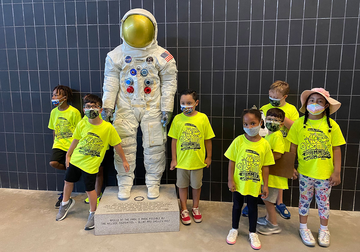Young multicultural children in front of astronaut exhibition at Udvar Hazy Center